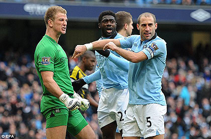 Joe Hart and his City team-mates celebrate wildly after the penalty save. Net photo.