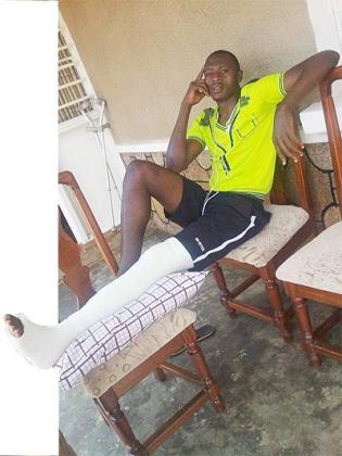 Jean Luc Ndayishimiye Bakame relaxing at his home with his broken left leg wrapped in plaster.  The New Times / P. Kamasa.