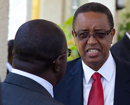 The incoming Infrastructure Minister Prof. Lwakabamba (R), chats with Prime Minister Dr. Pierre Damien Habumuremyi at Parliament yesterday.  The New Times/Timothy Kisambira.