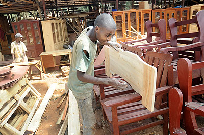 A lad at work in a furniture workshop in Gikinjiro. Youth in the country still face many challenges in contributing to nation building.  The New Times/ J. Mbanda.