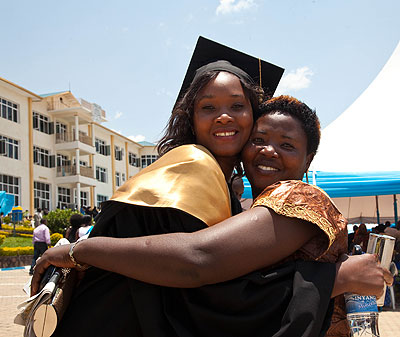 A mother congratulates her daughter upon her graduation.  The New Times/ Timothy Kisambira.