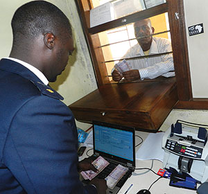 A trader pays tax at a customs point at Rusumo border. Tanzania and Rwanda have agreed to support small cross-borders traders. The New Times/ Stephen Rwembeho