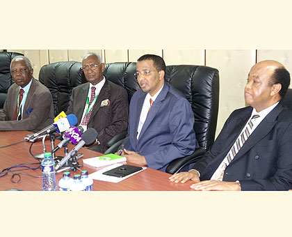 Hassan (C) addresses the media, yesterday, flanked by Abdulrahman Kinana (L), the head of EAC observers, and Veke Mubako of Comesa. The New Times/ Courtesy. 