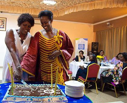 First Lady Jeannette Kagame (R) with  Pro-Femmes Twese Hamwe Chairperson Jeanne d'Arc Kanakuze, cut the cake to mark the 20th anniversary of the organisation.  Sunday Times/T. Kisambira.