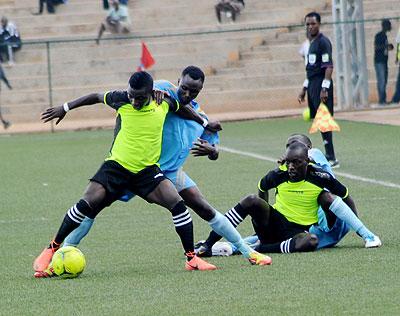 Police fullback Fredrick Ndaka tries to disposes LLB Academic striker Saidi Kayumba during their CAF Confederation Cup clash at Stade de Kigali on Saturday.  Sunday Sport / J. Mbanda.