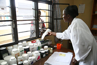A pharmacist offers drugs to a patient in a local hospital.The New Times / File. 