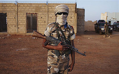 An ethnic Tuareg Malian soldier stands guard at a checkpoint in Gao. Net photo.