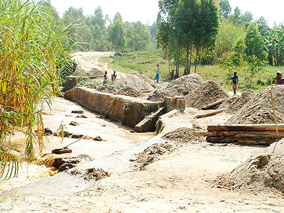 Sand miners at heaps of their products in Kinyinya sector recently. The New Times/ File.