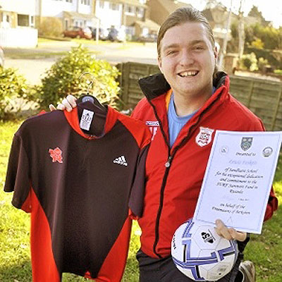 Lewis Foskett from Sandhurst is raising money for his football coaching trip to Rwanda by selling an Olympic shirt signed by double gold medallist Mo Farrah. Net photo