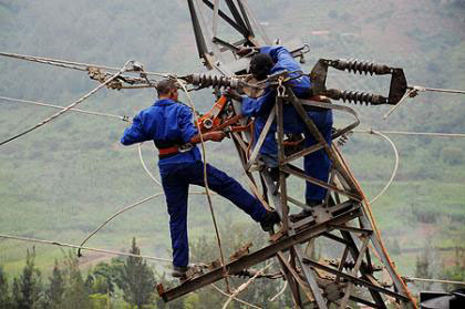 Energy Water and Sanitation Authority (EWSA) workers fix a power transmission line. The New Times / File.