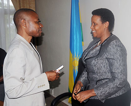 Gasinzigwa (R) chats with the deputy Chief Gender Monitor, Ramadhan Barengayabo in Kigali on Tuesday. The New Times/ John Mbanda. 