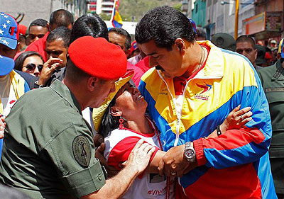 Vice President Nicolu00e1s Maduro on Wednesday consoled a supporter of President Hugo Chu00e1vez. Net photo.