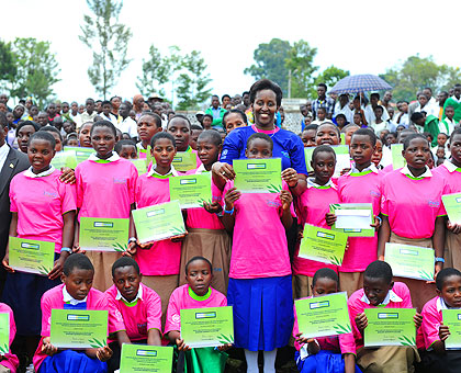 The First Lady, Jeannette Kagame, poses with some of last yearu2019s best performing girl students. Mrs Kagame observed that, if girls are acquainted with the importance of dignit....