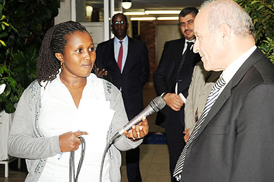 A female Rwanda TV journalist interviews a source. The New Times/ File.