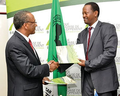 Kayonga and Negatu Makonnen, the AfDB country chief exchange the $8m funding deal documents earlier this week.  
