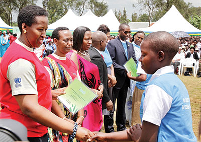 First Lady of Rwanda rewards a best performing girl in 2012 Girls Education campaign. The New Times/Courtesy.
