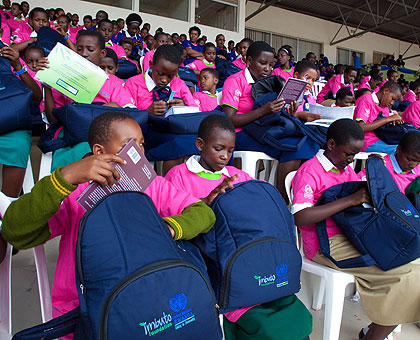 Some of last yearu2019s best performing girls check through gifts received from Imbuto Foundation yesterday. The New Times/ Timothy Kisambira. 