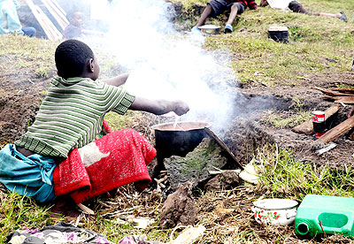 A Congolese refugee prepares food in a camp. The New Times/  File