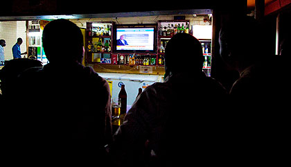 Kenyatta supporters intently follow news at home from a screen.  The New Times/  T. Kisambira.