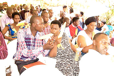 Farmers enjoy boiled maize during the function. The New Times/ Steven Rwembeho.