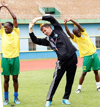 Micho, front, taking his players, striker Meddy Kagere,left, and defender Ismail Nshutiyamagara, through drills during a training session.  The New Times / T. Kisambira.