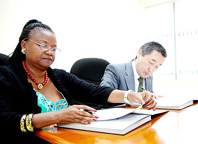 Shigeru (R) and Mukarugwira during the signing ceremony. The New Times/ Timothy Kisambira.