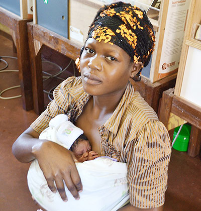 A mother protects her baby.  The New Times/ File.