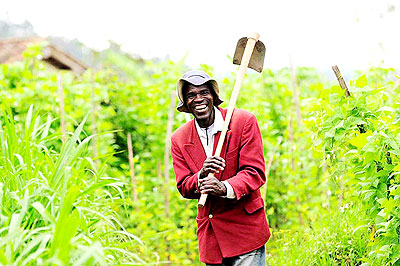 A farmer radiates with a smile after a dayu2019s labour. The Premier has called for hard work in the new season.  The New Times/ Timothy Kisambira.