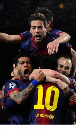 Barcelona players celebrate with Lionel Messi after he scored his team's second goal against AC Milan. Net photo.
