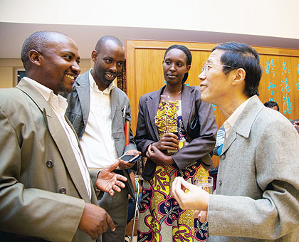 Zhan (R) interacts with some Rwandans who have benefited from Chinese government training. The New Times/ Timothy Kisambira.