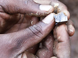 A miner displays wolfram. The government is moving to strengthen inspection at mining sites.  The New Times/ File