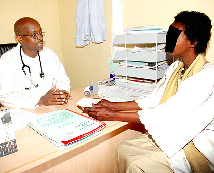 A doctor examines a patient in a Kigali hospital recently.   The New Times/  File.