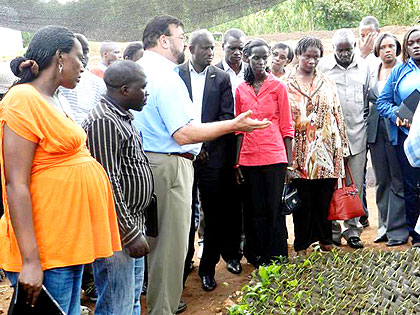 Jones explains to the touring leaders about his agro-forestry activities in Kigabiro sector.  The New Times/  Stephen Rwembeho.