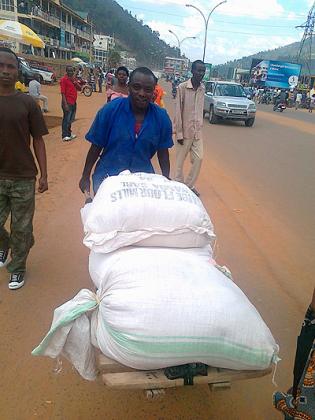 Habyarimana ferries sacks of maize flour in Nyabugogo. 