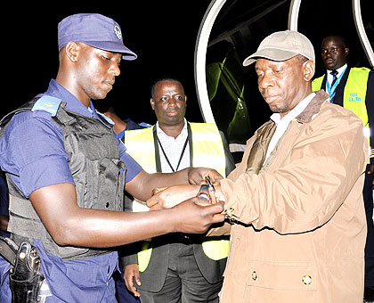 Bandora (R) is officially arrested at Kigali Internation Airport after his extradition from Norway last week.  The New Times/ File.