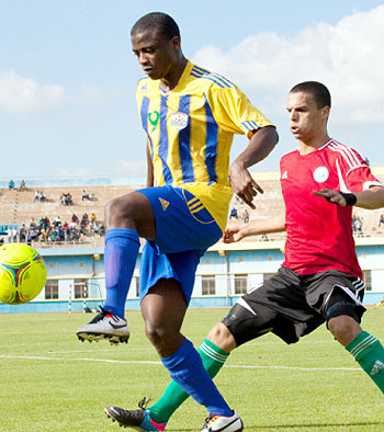 Above: Striker Elias Uzamukunda shields the ball from Libya's Swanei Abobaker in yesterday's friendly match held at Amahoro stadium.  Inset: Mali coach Patrice Carteron and his assista....