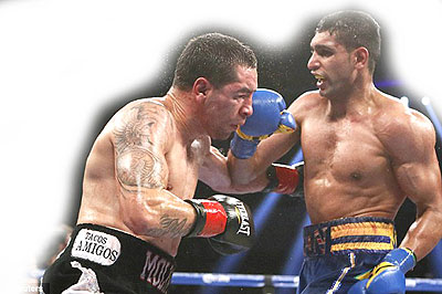 Amir Khan (right) forced Carlos Molina to retire at the end of the 10th round last December. Net photo Net photo.