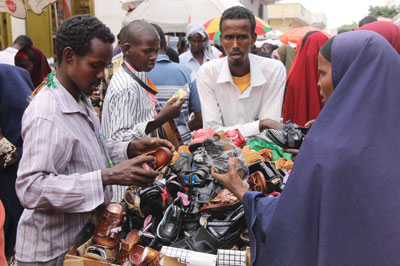 Shoppers buy shoes at the main Bakara market, in Mogadishu, capital of Somalia. Net photo