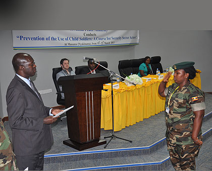 A participant from Uganda receives a certifcate  from Murekezi. The New Times/ Clement Uwiringiyimana. 