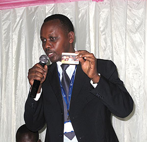 Ngunga displaying the Visa card at the meeting over the weekend. The New Times/ Stephen Rwembeho
