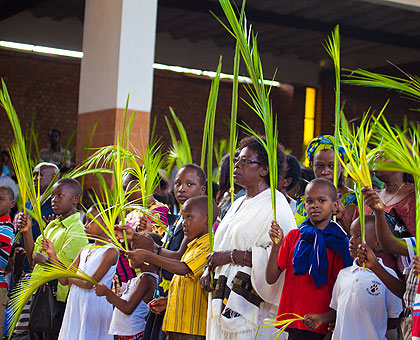 Part of the congregation at St. Michael Cathedral  wave palm leaves during mass yesterday. The New Times/T. Kisambira. 