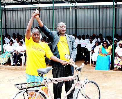 A health volunteer (L) is rewarded for her efforts in fighting TB.  The New Times/  Jean P. Bucyensenge.