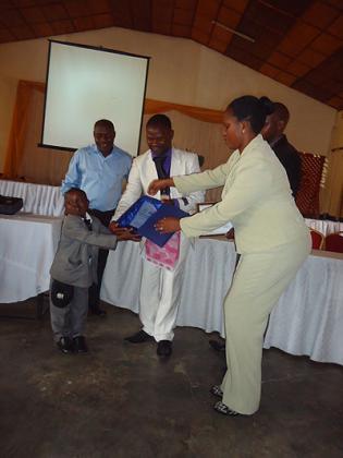 Hotel Muhaburau2019s Rudakubana, 48, (left) receiving the award on behalf of the hotel. The New Times / Ivan Ngoboka