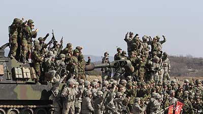 South Korean and U.S. army, gray, soldiers cheer after a live fire drill during the annual Foal Eagle maneuvers near Rodriguez Range in Pocheon, south of the demilitarised zone that di....