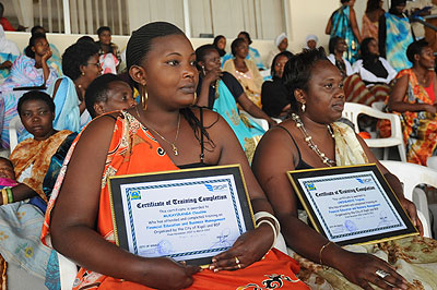 Women entrepreneurs pose with certificates they were awarded for their achievements. The New Times/  John Mbanda.