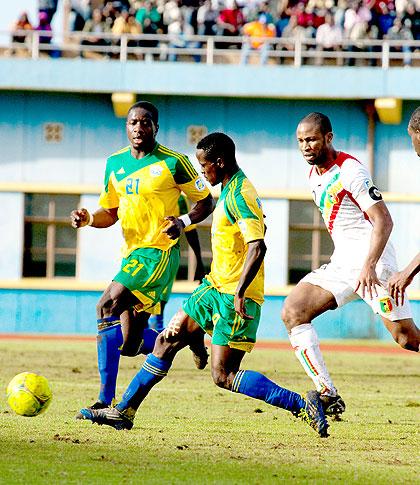 Amavubiu2019s Haruna Niyonzima runs with the ball past Maliu2019 skipper Seydou Keita in a World Cup qualifier held in Kigali last Sunday. Rwanda lost 2-1. The New Times /T. Kisambira.