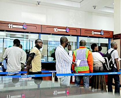 Clients queue in a city bank. A new project by MFIs could see many children learn savings culture at tender age.  The New Times/ File.