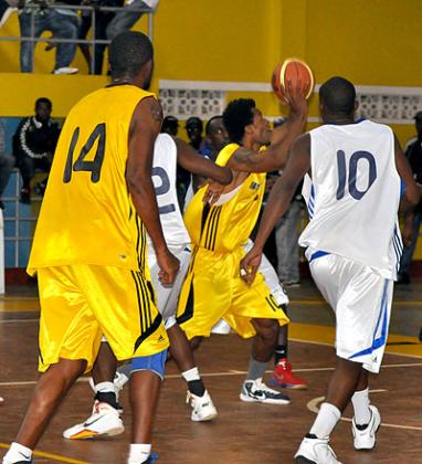 Mike Bazangu (with the ball) and Kami Kabange (shirt 14) are the two most experinced players on the team for this year's Afro-basket championship. The New Times / P. Muzogeye.
