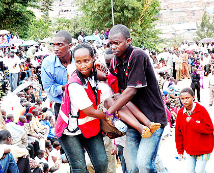 Red Cross volunteers evacuate a child who had collapsed during a past commemoration in Kigali.   The New Times/ John Mbanda.