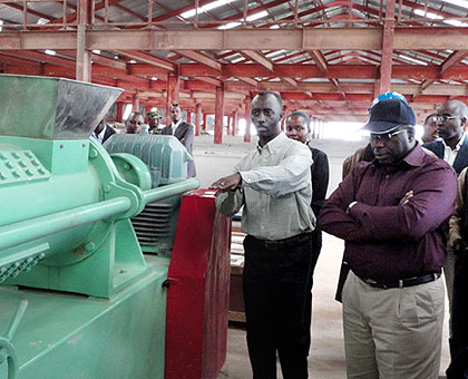 Prime Minister Pierre Damien Habumuremyi (R) is shown around a tea factory in Nyamagabe owned by Multi-sectoral Investment Group in January. The New Times/File.